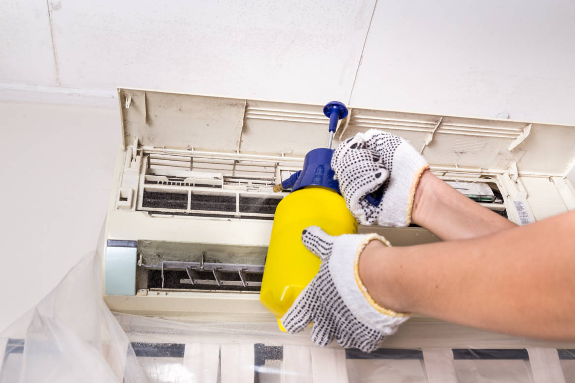 technician-spraying-chemical-water-onto-air-PPEB8PH.jpg